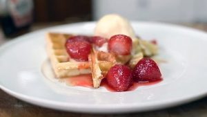 Waffles with strawberry compôte and ice cream