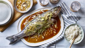 Steamed whole sea bass with garlic, ginger and spring onions